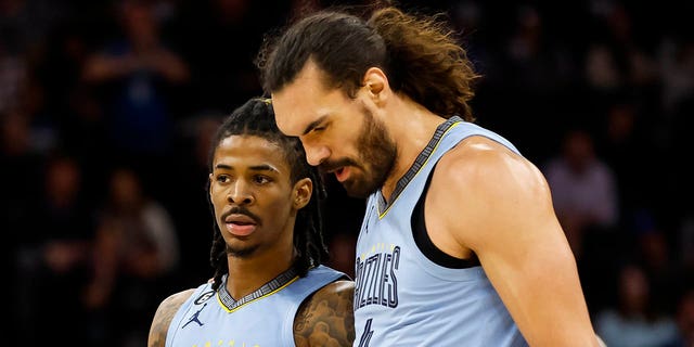 Ja Morant, #12, and Steven Adams, #4 of the Memphis Grizzlies, interact in the second quarter of the game against the Minnesota Timberwolves at Target Center on Nov. 30, 2022 in Minneapolis.