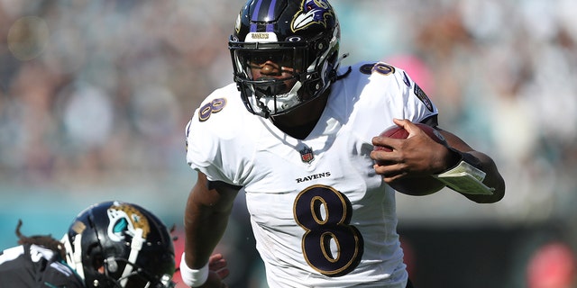 Baltimore Ravens quarterback Lamar Jackson carries the ball against the Jaguars at TIAA Bank Field on Nov. 27, 2022, in Jacksonville, Florida.