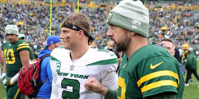 Zach Wilson of the New York Jets speaks with the Packers' Aaron Rodgers after their game at Lambeau Field on Oct. 16, 2022, in Green Bay, Wisconsin.