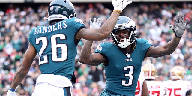 Miles Sanders (26) of the Philadelphia Eagles celebrates with Zach Pascal (3) after scoring a 6-yard touchdown against the San Francisco 49ers during the first quarter in the NFC championship game at Lincoln Financial Field Jan. 29, 2023, in Philadelphia. 