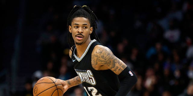 Ja Morant #12 of the Memphis Grizzlies brings the ball up court during the second half of the game against the Charlotte Hornets at Spectrum Center on January 04, 2023 in Charlotte, North Carolina.