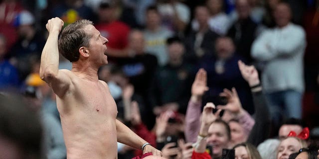 Arkansas head coach Eric Musselman celebrates with fans after beating Kansas in the NCAA Tournament, Saturday, March 18, 2023, in Des Moines, Iowa.