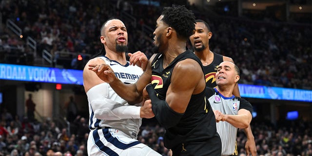 Dillon Brooks of the Memphis Grizzlies, left, fights with Donovan Mitchell of the Cleveland Cavaliers, right, during the third quarter at Rocket Mortgage Fieldhouse Feb. 2, 2023, in Cleveland.