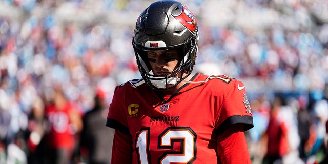 Tampa Bay Buccaneers quarterback Tom Brady, #12, walks off the field at halftime during the first half of an NFL football game against the Carolina Panthers Sunday, Oct. 23, 2022, in Charlotte, North Carolina.