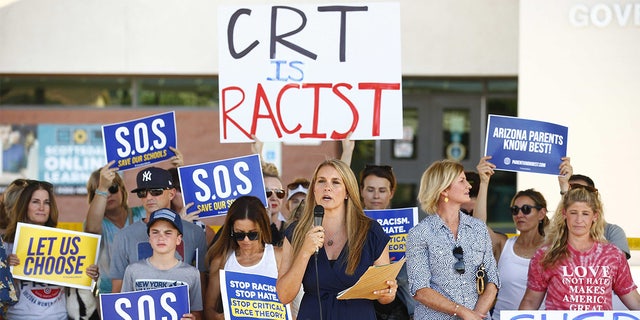 Amy Carney speaks on behalf of parents during a protest against critical race theory being taught at Scottsdale Unified School District before a digital school board meeting at Coronado High School in Scottsdale on May 24, 2021.