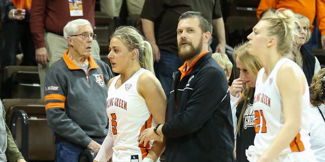 Bowling Green Falcons guard Elissa Brett (5), left, is assisted off of the court after an altercation with Memphis Tigers guard Jamirah Shutes (not pictured) during the postgame handshake following a third-round game in the Women's National Invitational Tournament March 23, 2023, at the Stroh Center in Bowling Green, Ohio.  