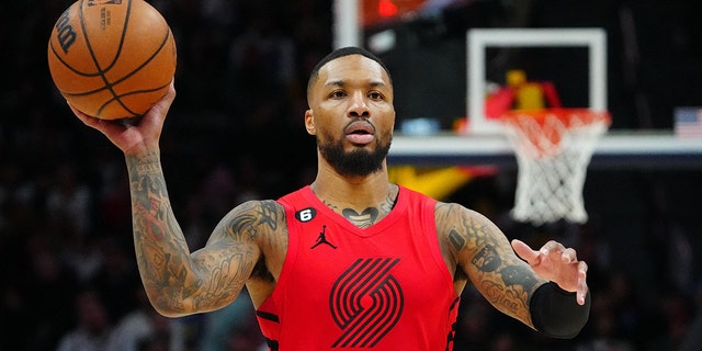 Portland Trail Blazers guard Damian Lillard (0) prepares to pass the ball in the second half against the Denver Nuggets at Ball Arena in Denver, Colo., Jan. 17, 2023.