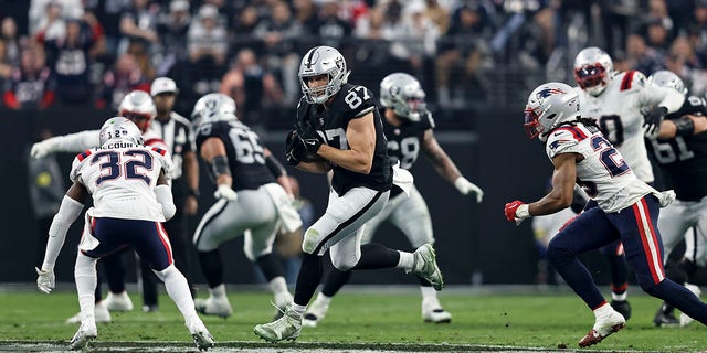 Foster Moreau (87) of the Las Vegas Raiders runs with the ball during a game against the New England Patriots at Allegiant Stadium Dec. 18, 2022, in Las Vegas. 