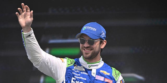 Daniel Suarez waves to fans as he walks onstage during driver intros prior to the NASCAR Cup Series EchoPark Automotive Grand Prix on March 26, 2023, in Austin, Texas.