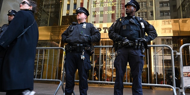 NEW YORK, NEW YORK - MARCH 21: A woman walks past Trump Tower after  NYPD officers set up step barricades after a small crowd gathers on March 21, 2023 in New York City. NYC and other cities are bracing for a possible indictment of former President Donald Trump by Manhattan District Attorney Alvin Bragg in his investigation into the former president's involvement in a hush money payment to adult film actress Stormy Daniels prior to the 2016 presidential election.