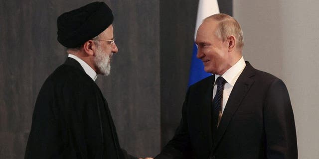 Russian President Vladimir Putin shakes hands with Iranian President Ebrahim Raisi during a meeting in Samarkand, Uzbekistan Sept. 15, 2022.