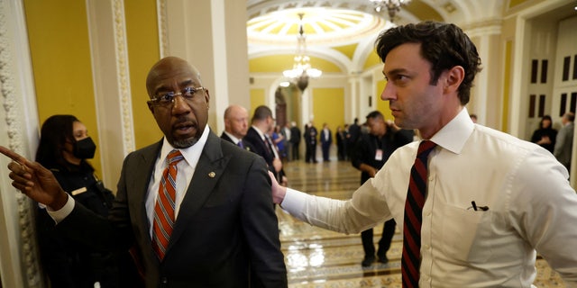 Senators Raphael Warnock (D-GA), left, and Jon Ossoff (D-GA) return to the Senate floor following the Senate Democrats weekly policy lunch at the U.S. Capitol. The party lunches are expected to be private affairs.