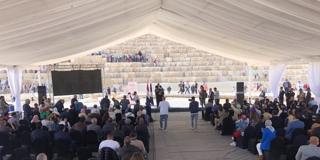 Egyptian Minister of Tourism and Antiquities Ahmed Issa talks to the media in front of the Great Pyramid of Giza.