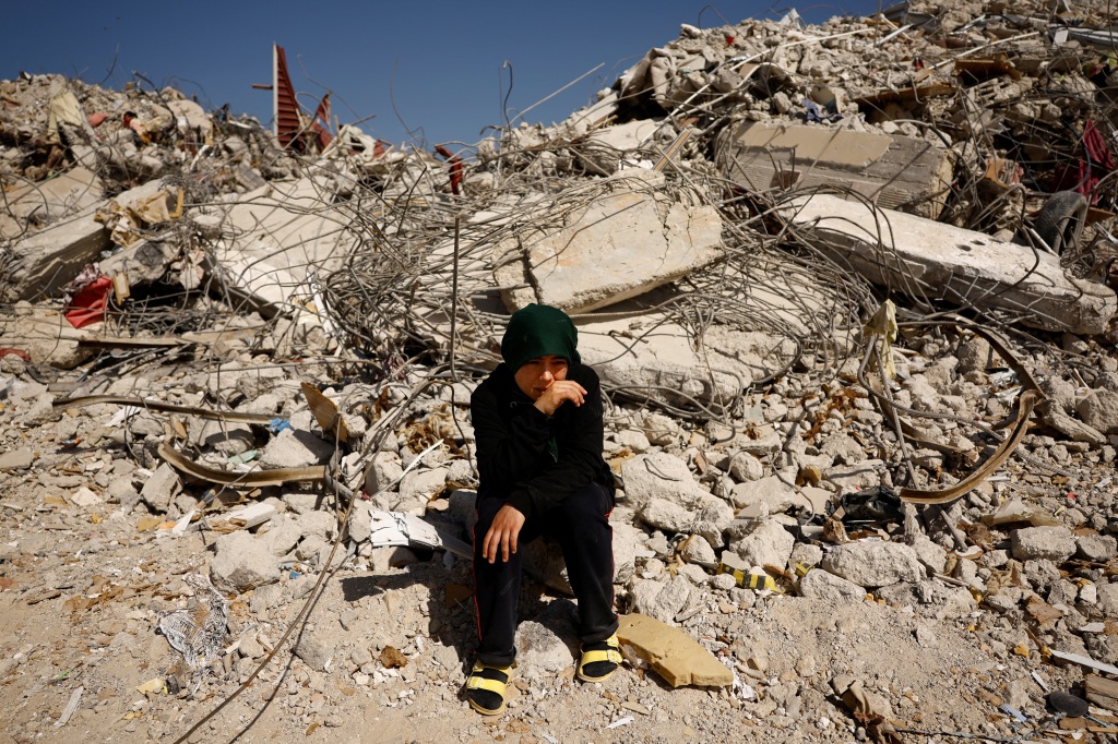 Fatmagul Arslan sits while visiting what is left of her home, where she was trapped for five days with her parents and two siblings until being rescued in Nurdagi, Turkey, on March 4, 2023. 