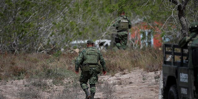 Military personnel walk at the scene where authorities found the bodies of two of four Americans kidnapped by gunmen, in Matamoros, Mexico March 7, 2023. 