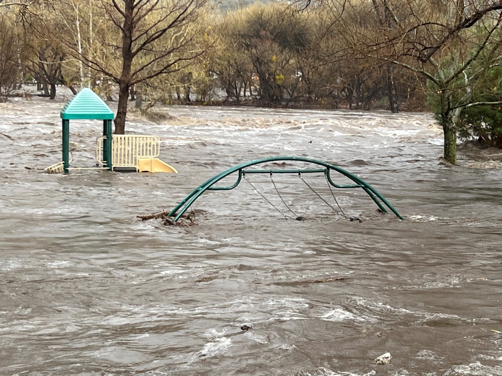 Playground equipment are submerged in the overflowing Kern River in Kernville, California on March 10, 2023.