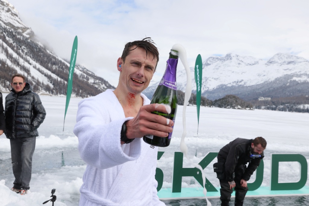 David Vencl celebrates after his successful attempt to dive under the ice of Lake Sils on March 14, 2023. 