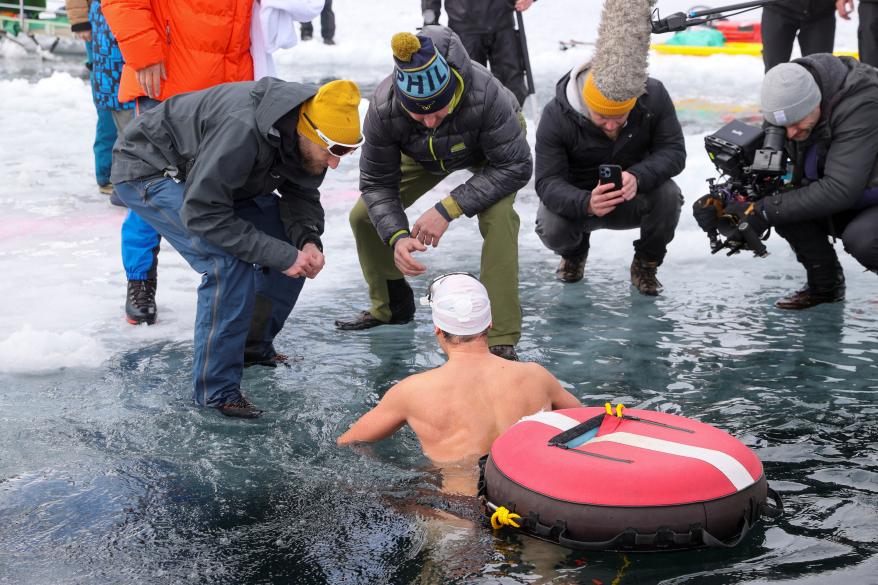 Czech free-diver David Vencl comes out of the water after his dive under the ice of Lake Sils on March 14, 2023.