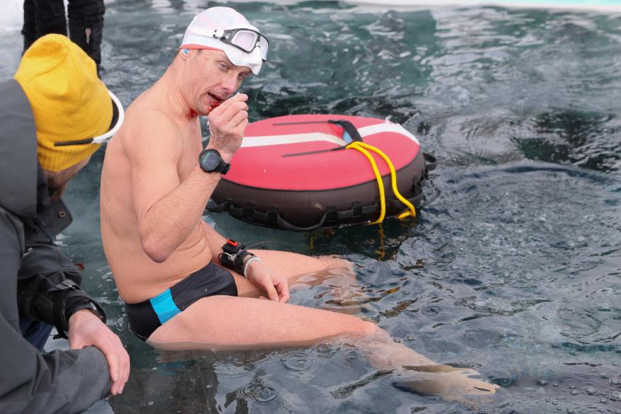 David Vencl gestures after coming up out the water in Lake Sils on March 14, 2023.