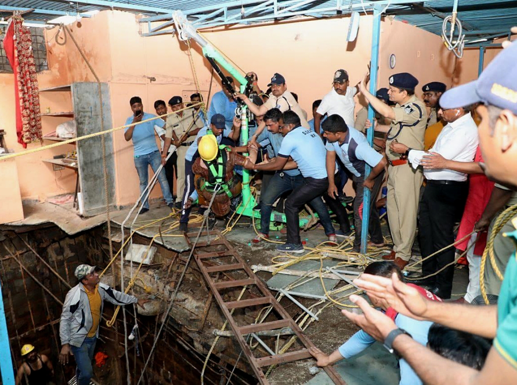 Rescuers work at the site of a floor cave-in inside the temple in Indore, India on March 30, 2023. 