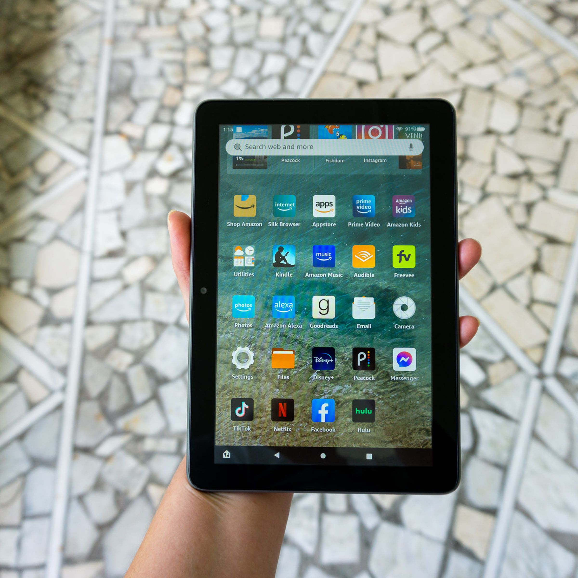 A person holding the Amazon Fire HD 8 Plus tablet