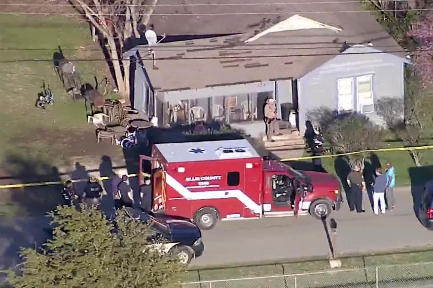 An ambulance is parked outside the Italy, Texas home where five children were stabbed by their mother, on Friday.