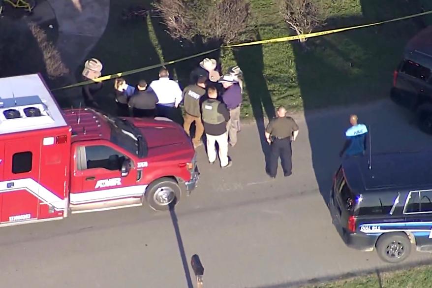 First responders stand on the road outside of the home where a mother stabbed her five children in Italy, Texas.