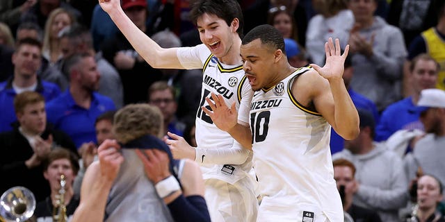 Jackson Francois, #12, and Nick Honor, #10 of the Missouri Tigers, celebrate after defeating the Utah State Aggies in the first round of the NCAA Men's Basketball Tournament at Golden 1 Center on March 16, 2023 in Sacramento, California.