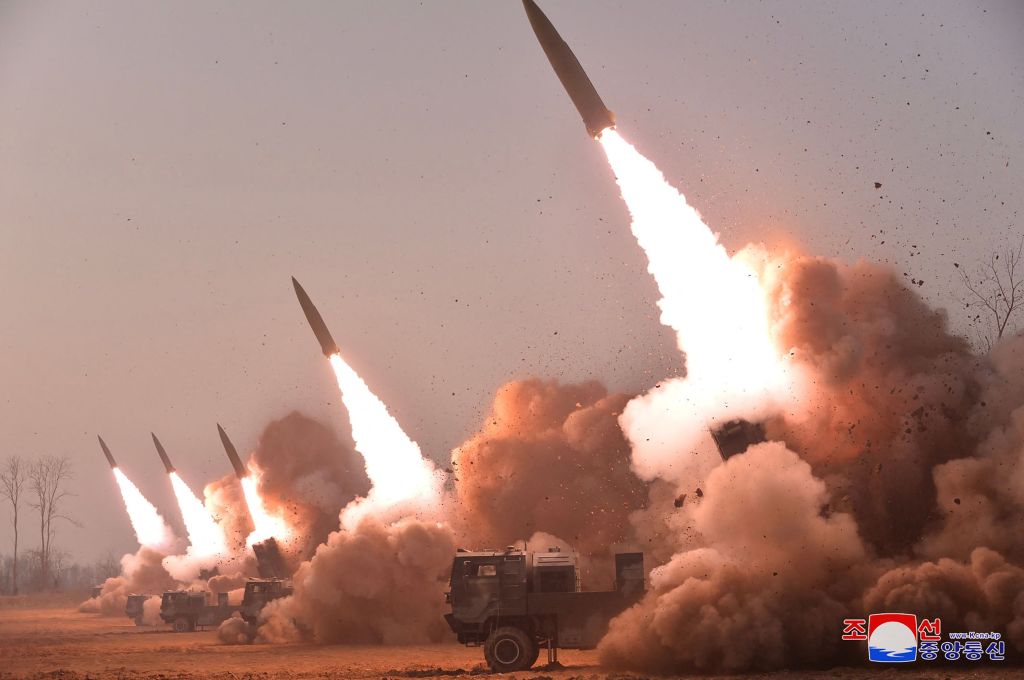 Missiles launch from a Hwasong Artillery unit during the training on March 10, 2023.