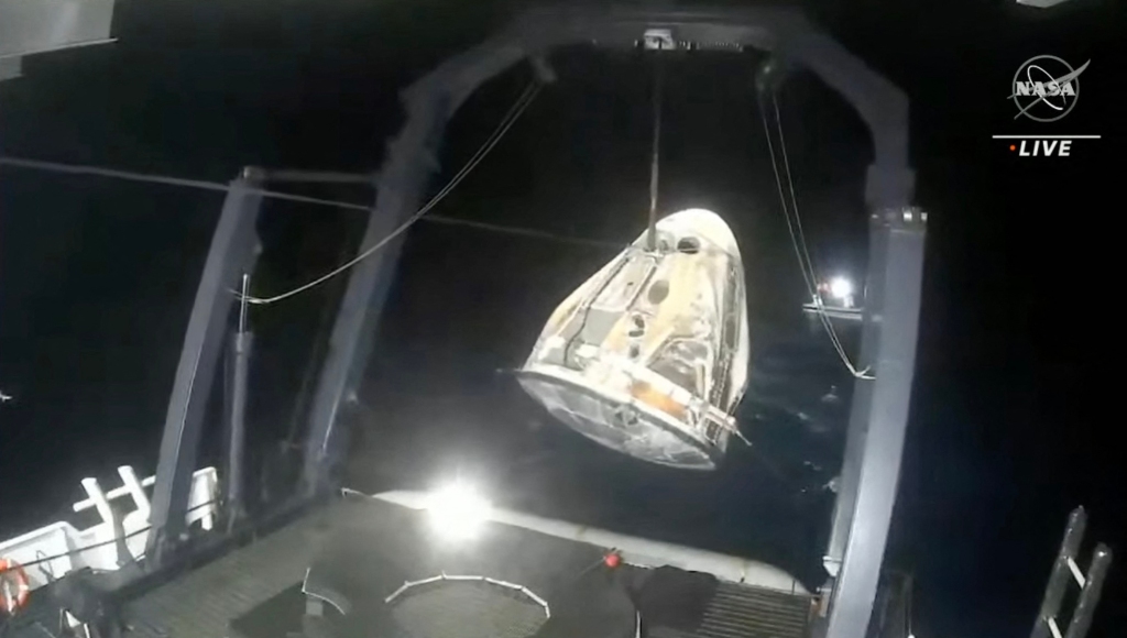 The capsule is lifted out of the water onto a recovery ship after landing in the Gull of Mexico off the coast of Tampa, Florida.