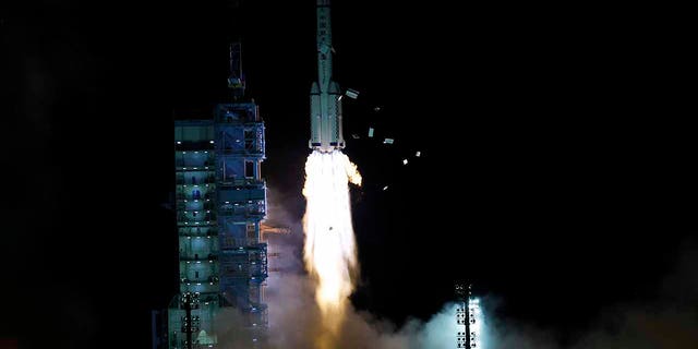 The crewed spaceship Shenzhou-13, atop a Long March-2F carrier rocket, is launched from the Jiuquan Satellite Launch Center in northwest China's Gobi Desert, Oct. 16, 2021.