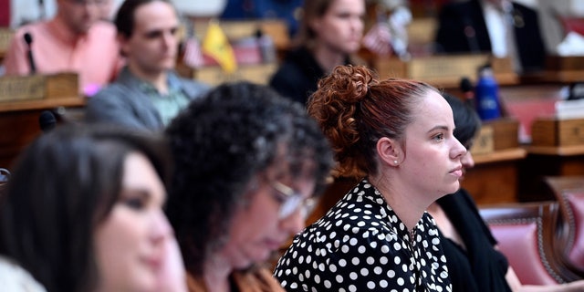 Catherine Jones watches people speak during public hearing in the House of Delegates Chamber for a bill that would codify the right of West Virginia residents to challenge government regulations that interfere with their religious beliefs, Friday, Feb. 24, 2023.