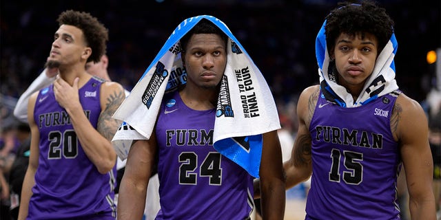 Furman forward Jalen Slawson (20), forward Alex Williams (24) and forward Tyrese Hughey (15) leave the court after their loss to San Diego State in a second-round college basketball game in the NCAA Tournament, Saturday, March 18, 2023, in Orlando, Fla. 