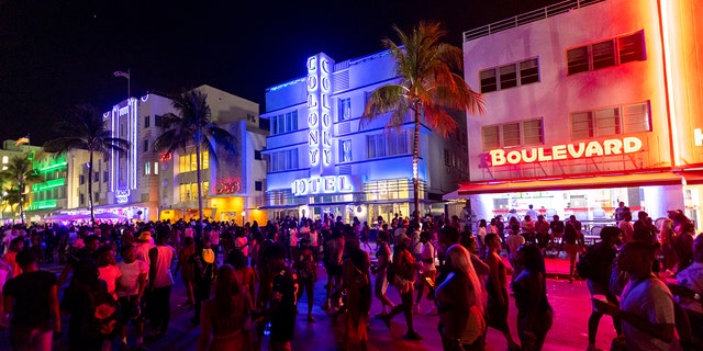 Crowds walk up and down Ocean Drive during spring break on Saturday, March 18, 2023, in Miami Beach, Fla. 