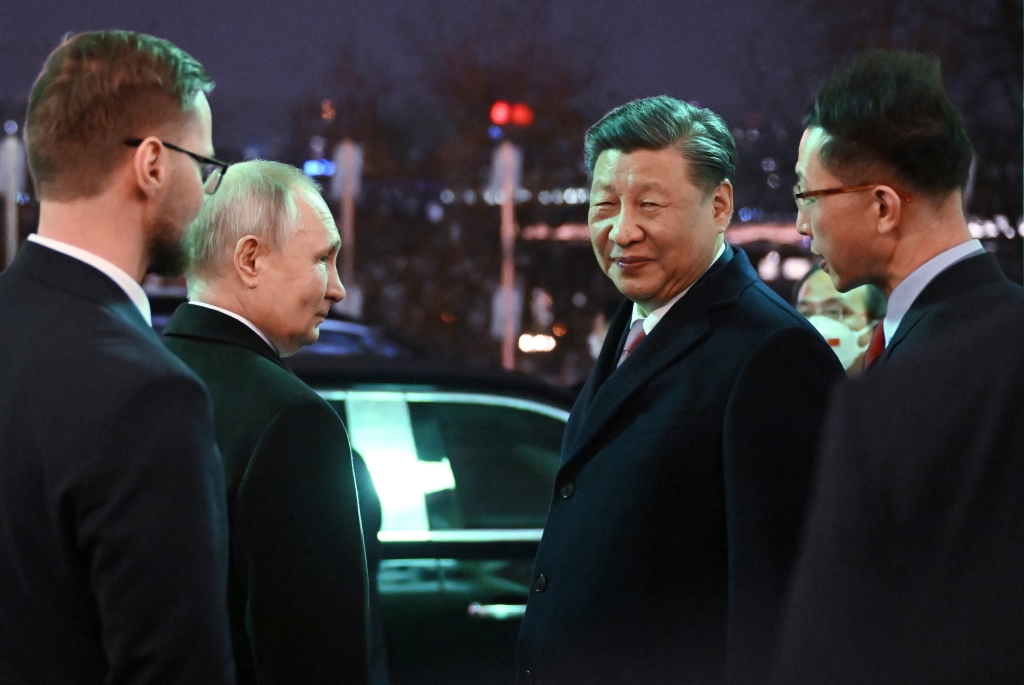 Chinese President Xi Jinping, right, and Russian President Vladimir Putin talk to each other prior to Chinese President Xi Jinping leaving after their dinner in Kremlin, Russia.