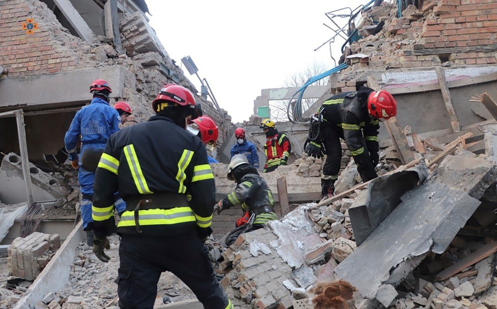 Emergency personnel work at the scene following a drone attack in the town of Rzhyshchiv, Kyiv region, Ukraine on March 22, 2023. 