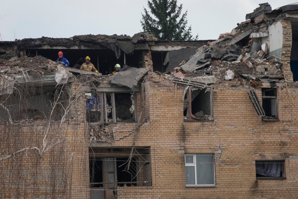 Emergency personnel work at the scene following a drone attack in the town of Rzhyshchiv, Kyiv region, Ukraine on March 22, 2023. 