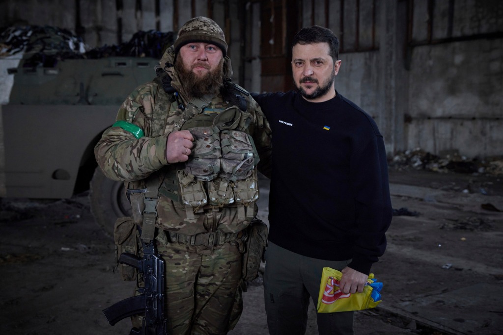 Ukrainian president Volodymyr Zelensky and a soldier pose for a photo after an awarding ceremony at a position near the Donetsk region of Ukraine on March 22, 2023. 