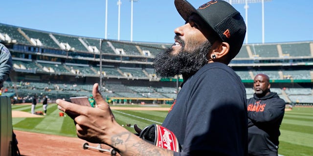 San Francisco Giants pitcher Sergio Romo visits with fans before the start of a spring training baseball game against the Oakland Athletics in Oakland, Calif., Sunday, March 26, 2023. The Giants plan to have Romo pitch on Monday at Oracle Park to mark his retirement. 