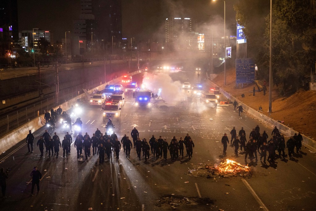Israeli police disperse demonstrators blocking a highway during a protest against plans by Prime Minister Benjamin Netanyahu's government in Tel Aviv, Israel on March 27, 2023. 