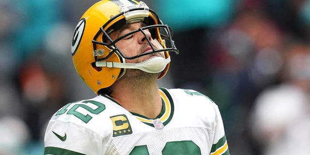 Miami Gardens, Florida, USA; Green Bay Packers quarterback Aaron Rodgers (12) reacts while walking off the field after a failed attempt to convert a third down during the first half against the Miami Dolphins at Hard Rock Stadium.