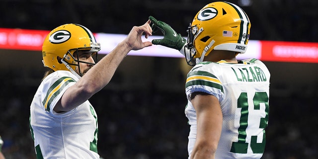 Green Bay Packers wide receiver Allen Lazard, right, is congratulated by quarterback Aaron Rodgers after a 29-yard pass for a touchdown during the first half of an NFL football game against the Detroit Lions, Sunday, Jan. 9, 2022, in Detroit.