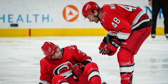 Andrei Svechnikov #37 of the Carolina Hurricanes reacts after suffering an injury during the second period against the Philadelphia Flyers at PNC Arena on March 09, 2023 in Raleigh, North Carolina.