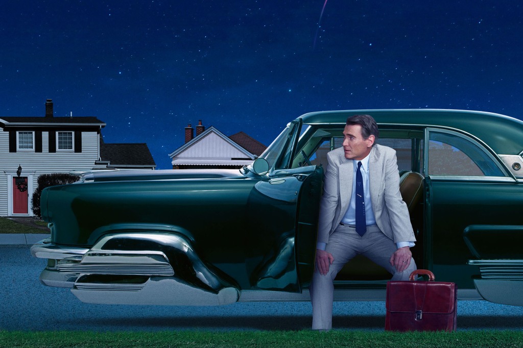 Jack Billings (Tommy Crudup) sits in a hover car on "Hello Tomorrow!" He's got his hands on his knees and he's sitting facing the outside of the car. There's a briefcase next to him on the lawn.