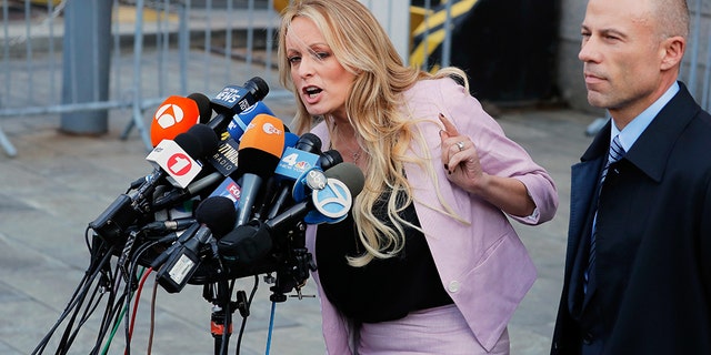 Adult film actress Stephanie Clifford, also known as Stormy Daniels, speaks to media along with lawyer Michael Avenatti (R) outside federal court in the Manhattan borough of New York City, April 16, 2018.