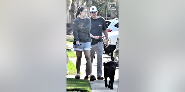 Buster Murdaugh and Brooklynn White walk their dogs in Hilton Head, SC, Saturday, March 4, 2023. Buster's father, Alex Murdaugh, was sentenced to a double life sentence yesterday for the murders of Buster's mother and brother in 2021.