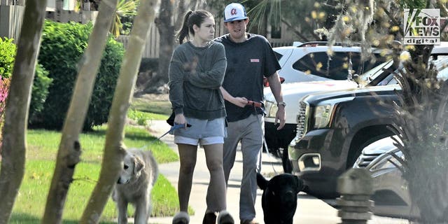 Buster Murdaugh and Brooklynn White walk their dogs in Hilton Head, SC, Saturday, March 4, 2023. Buster's father, Alex Murdaugh, was sentenced to a double life sentence yesterday for the murders of Buster's mother and brother in 2021.