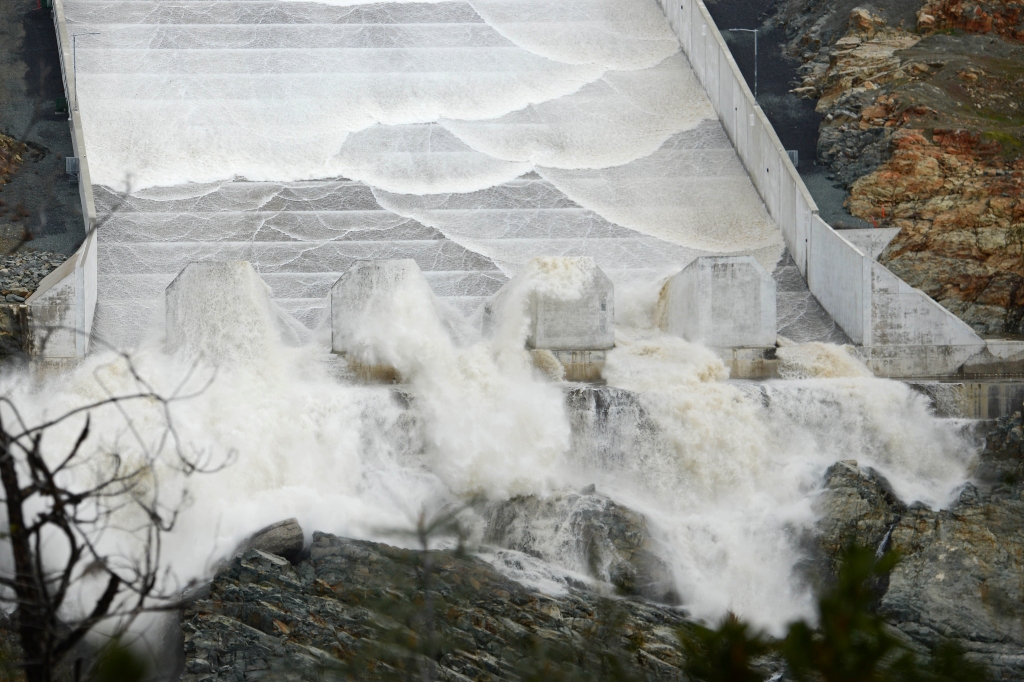 Water flows down Oroville Dam's main spillway after heavy rains filled the reservoir so much, officials opened the dam's spillway on Friday. 