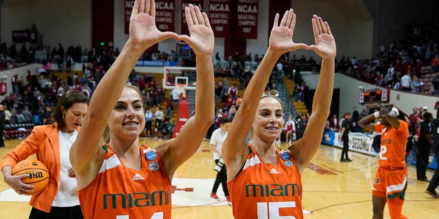 Miami's Haley Cavinder, #14, and Hanna Cavinder, #15, celebrate after Miami defeated Indiana in a second-round college basketball game in the women's NCAA Tournament Monday, March 20, 2023, in Bloomington, Indiana.