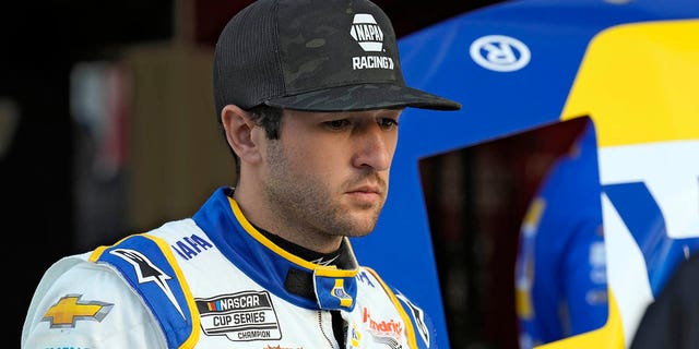 Chase Elliott watches as his crew works on his car during a practice for the NASCAR Daytona 500 Friday, Feb. 17, 2023, at Daytona International Speedway.